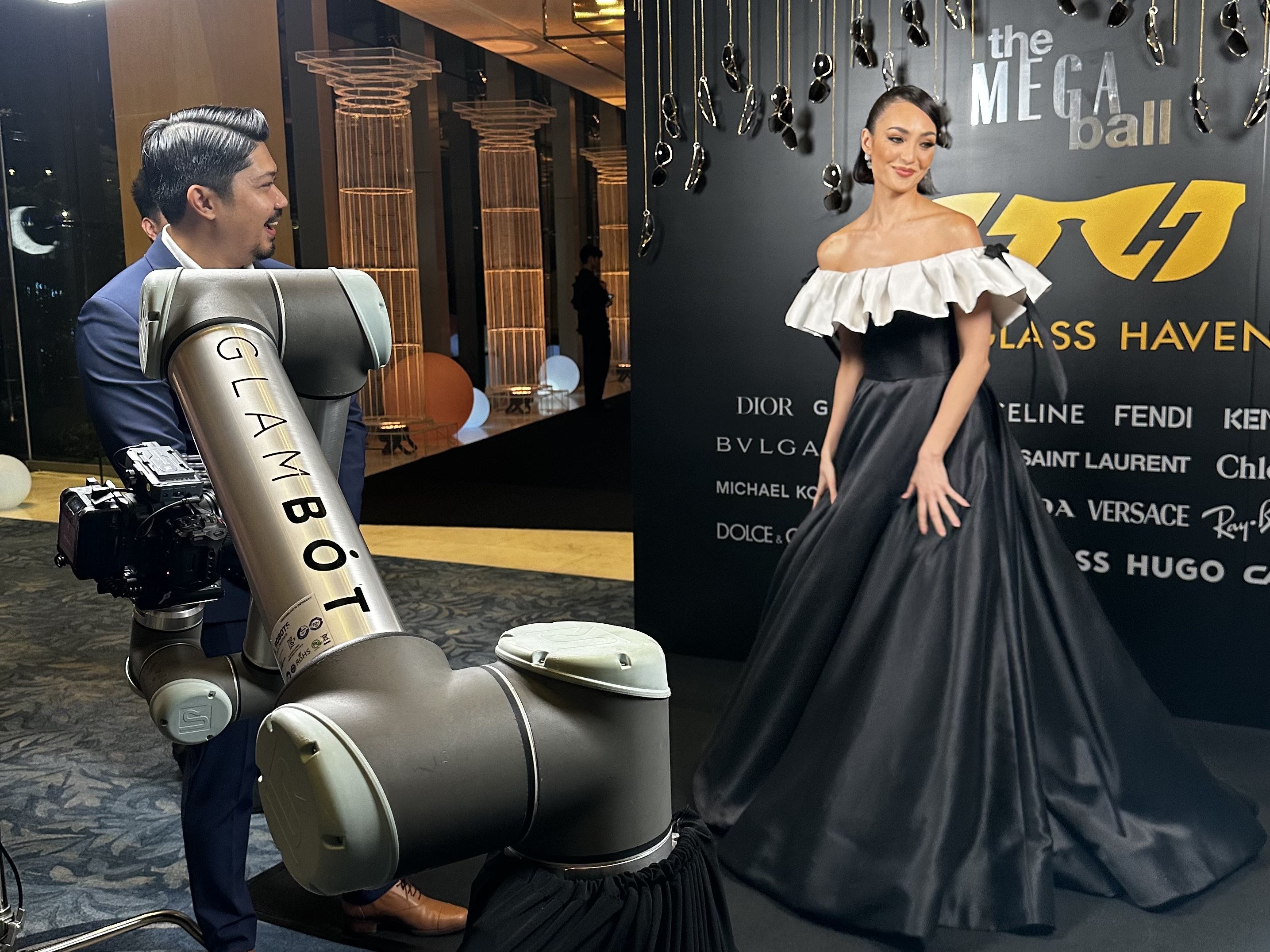 The GlamBot arm and operator filming a guest on the red carpet at The Mega Ball
