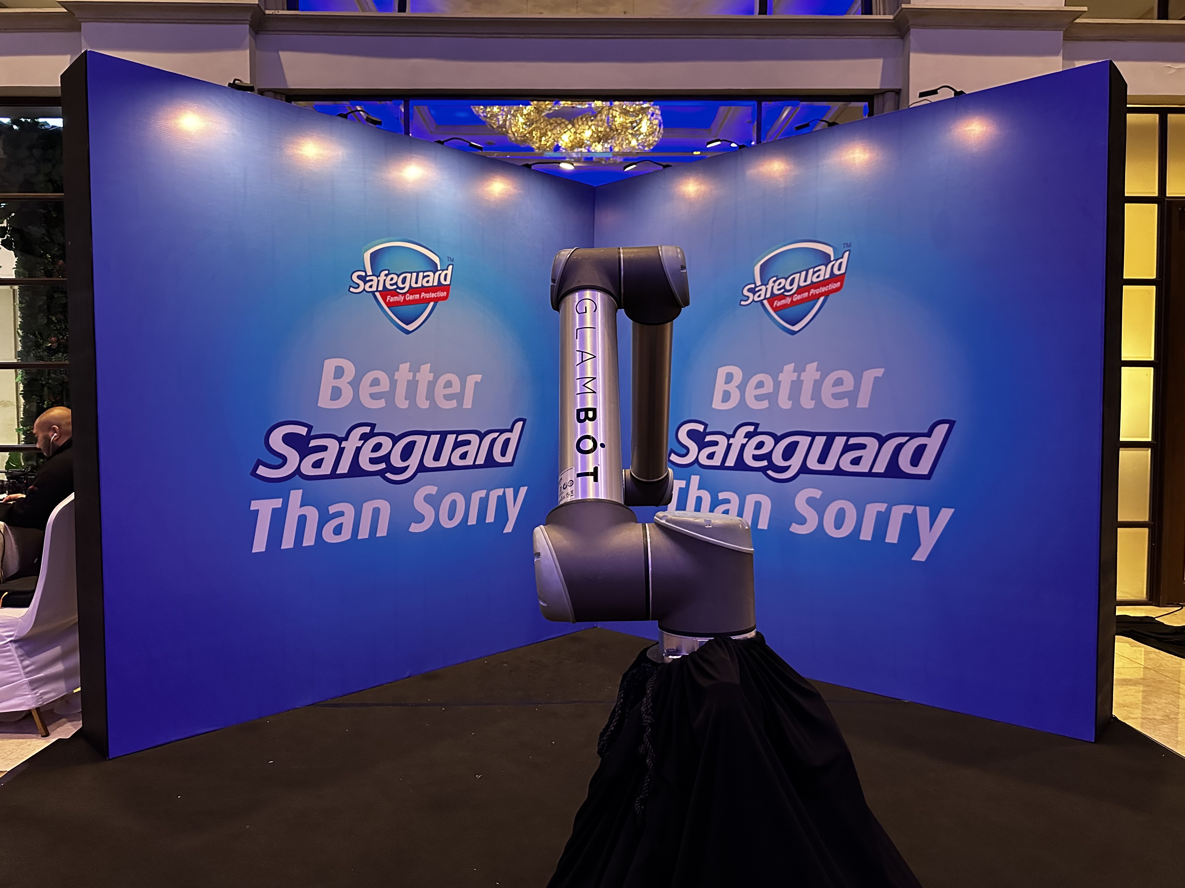 The GlamBot arm centered on a branded Safeguard backdrop at the PAMET convention