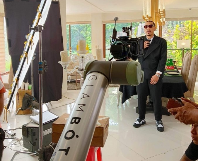 Behind the scenes of the GlamBot arm filming a TVC talent on set